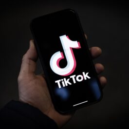Un telefon pe care apre logoul aplicației TikTok